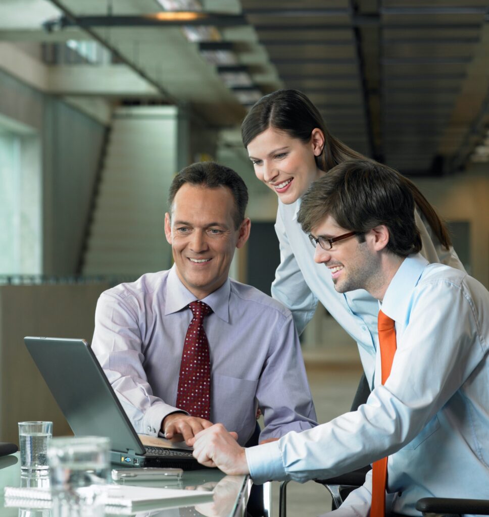 Three Businesspeople looking on laptop